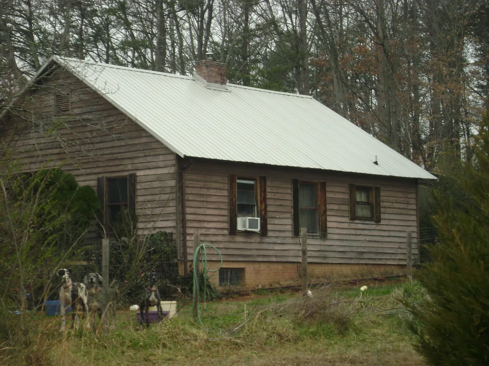 White metal roof on an old wood sided farmhouse, from a Metal Roof Installation job in Elwood